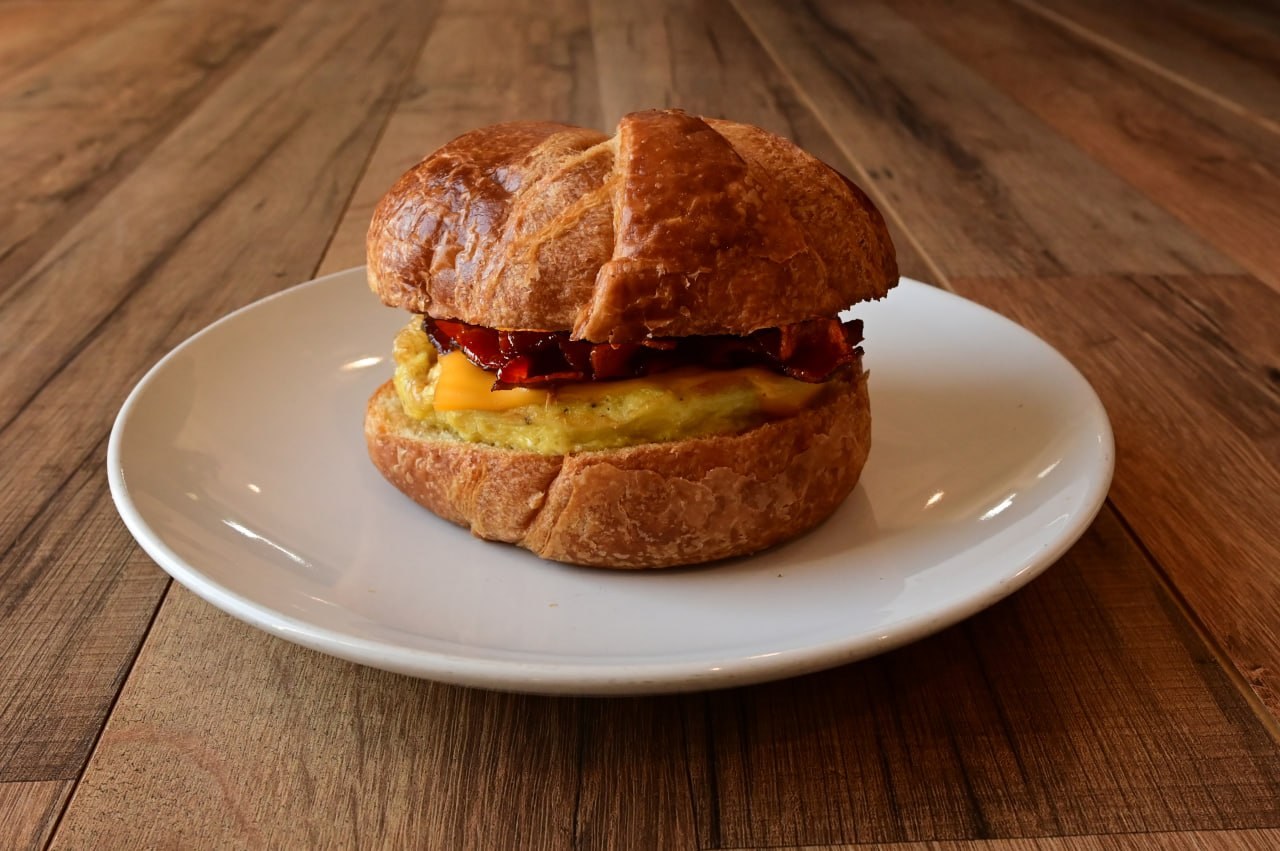 Croissant breakfast sandwich with bacon, egg, and cheese