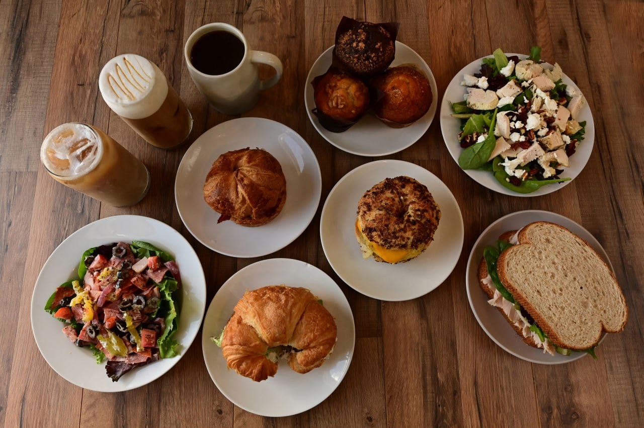 Meme’s Cafe spread with salads, sandwiches, drinks, and muffins