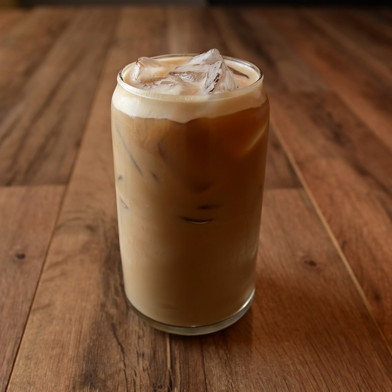 Iced latte on a wood table at Meme’s Cafe
